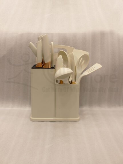 Off-white 19-piece silicone kitchen utensil and knife set with rose gold accents sitting in a dual caddy block on a countertop.