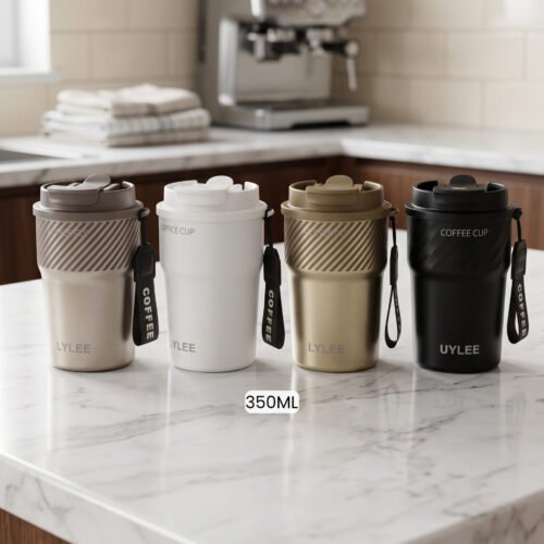 Four 350ml LYLEE insulated travel coffee mugs in taupe, white, olive green, and matte black lined up on a marble countertop.