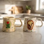 Handcrafted cream ceramic coffee mug featuring hand-painted botanical flower artwork, a scalloped rim, and an ergonomic wavy handle sitting on a marbleHandcrafted cream ceramic coffee mug featuring hand-painted botanical flower artwork, a scalloped rim, and an ergonomic wavy handle sitting on a marble countertop.Handcrafted cream ceramic coffee mug featuring hand-painted botanical flower artwork, a scalloped rim, and an ergonomic wavy handle sitting on a marble countertop.Handcrafted cream ceramic coffee mug featuring hand-painted botanical flower artwork, a scalloped rim, and an ergonomic wavy handle sitting on a marble countertop.Handcrafted cream ceramic coffee mug featuring hand-painted botanical flower artwork, a scalloped rim, and an ergonomic wavy handle sitting on a marble countertop.Handcrafted cream ceramic coffee mug featuring hand-painted botanical flower artwork, a scalloped rim, and an ergonomic wavy handle sitting on a marble countertop.Handcrafted cream ceramic coffee mug featuring hand-painted botanical flower artwork, a scalloped rim, and an ergonomic wavy handle sitting on a marble countertop.Handcrafted cream ceramic coffee mug featuring hand-painted botanical flower artwork, a scalloped rim, and an ergonomic wavy handle sitting on a marble countertop.Handcrafted cream ceramic coffee mug featuring hand-painted botanical flower artwork, a scalloped rim, and an ergonomic wavy handle sitting on a marble countertop.Handcrafted cream ceramic coffee mug featuring hand-painted botanical flower artwork, a scalloped rim, and an ergonomic wavy handle sitting on a marble countertop.Handcrafted cream ceramic coffee mug featuring hand-painted botanical flower artwork, a scalloped rim, and an ergonomic wavy handle sitting on a marble countertop.Handcrafted cream ceramic coffee mug featuring hand-painted botanical flower artwork, a scalloped rim, and an ergonomic wavy handle sitting on a marble countertop.Handcrafted cream ceramic coffee mug featuring hand-painted botanical flower artwork, a scalloped rim, and an ergonomic wavy handle sitting on a marble countertop.Handcrafted cream ceramic coffee mug featuring hand-painted botanical flower artwork, a scalloped rim, and an ergonomic wavy handle sitting on a marble countertop.Handcrafted cream ceramic coffee mug featuring hand-painted botanical flower artwork, a scalloped rim, and an ergonomic wavy handle sitting on a marble countertop.Handcrafted cream ceramic coffee mug featuring hand-painted botanical flower artwork, a scalloped rim, and an ergonomic wavy handle sitting on a marble countertop.Handcrafted cream ceramic coffee mug featuring hand-painted botanical flower artwork, a scalloped rim, and an ergonomic wavy handle sitting on a marble countertop.Handcrafted cream ceramic coffee mug featuring hand-painted botanical flower artwork, a scalloped rim, and an ergonomic wavy handle sitting on a marble countertop.Handcrafted cream ceramic coffee mug featuring hand-painted botanical flower artwork, a scalloped rim, and an ergonomic wavy handle sitting on a marble countertop.Handcrafted cream ceramic coffee mug featuring hand-painted botanical flower artwork, a scalloped rim, and an ergonomic wavy handle sitting on a marble countertop.Handcrafted cream ceramic coffee mug featuring hand-painted botanical flower artwork, a scalloped rim, and an ergonomic wavy handle sitting on a marble countertop.Handcrafted cream ceramic coffee mug featuring hand-painted botanical flower artwork, a scalloped rim, and an ergonomic wavy handle sitting on a marble countertop.Handcrafted cream ceramic coffee mug featuring hand-painted botanical flower artwork, a scalloped rim, and an ergonomic wavy handle sitting on a marble countertop.Handcrafted cream ceramic coffee mug featuring hand-painted botanical flower artwork, a scalloped rim, and an ergonomic wavy handle sitting on a marble countertop.Handcrafted cream ceramic coffee mug featuring hand-painted botanical flower artwork, a scalloped rim, and an ergonomic wavy handle sitting on a marble countertop.Handcrafted cream ceramic coffee mug featuring hand-painted botanical flower artwork, a scalloped rim, and an ergonomic wavy handle sitting on a marble countertop. countertop.