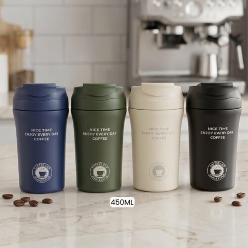 Four 450ml insulated travel coffee mugs in navy blue, olive green, cream, and matte black on a marble kitchen countertop