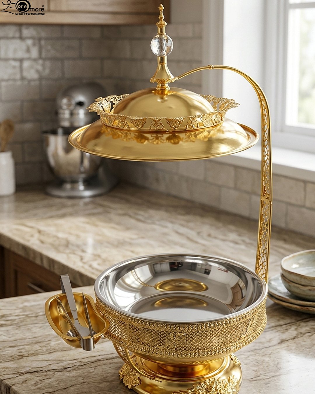 1 Luxury gold buffet chafing dish with overhead hanging dome lid, stainless steel food pan, and attached serving tongs.