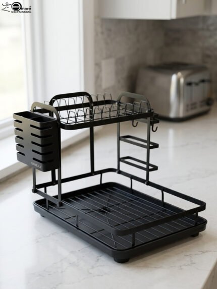 Modern 2-tier black metal dish drying rack with side utensil caddy and bottom drain tray on a kitchen countertop.