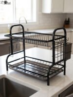2-tier black metal dish drying rack with removable drain tray and side utensil holder on a kitchen countertop