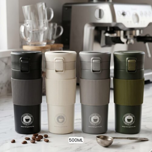 Four 500ml thermal travel coffee mugs in black, cream, grey, and olive green with silicone grips on a kitchen counter