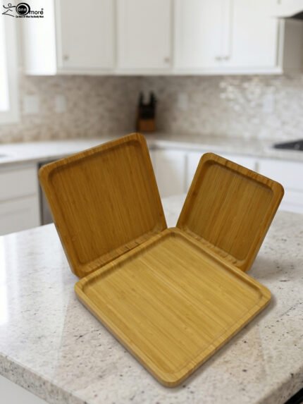 Set of 3 natural wooden square serving trays in small, medium, and large sizes displayed on a marble kitchen countertop.