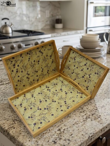 3 piece wooden serving tray set with floral printed base and built in handles on a kitchen countertop