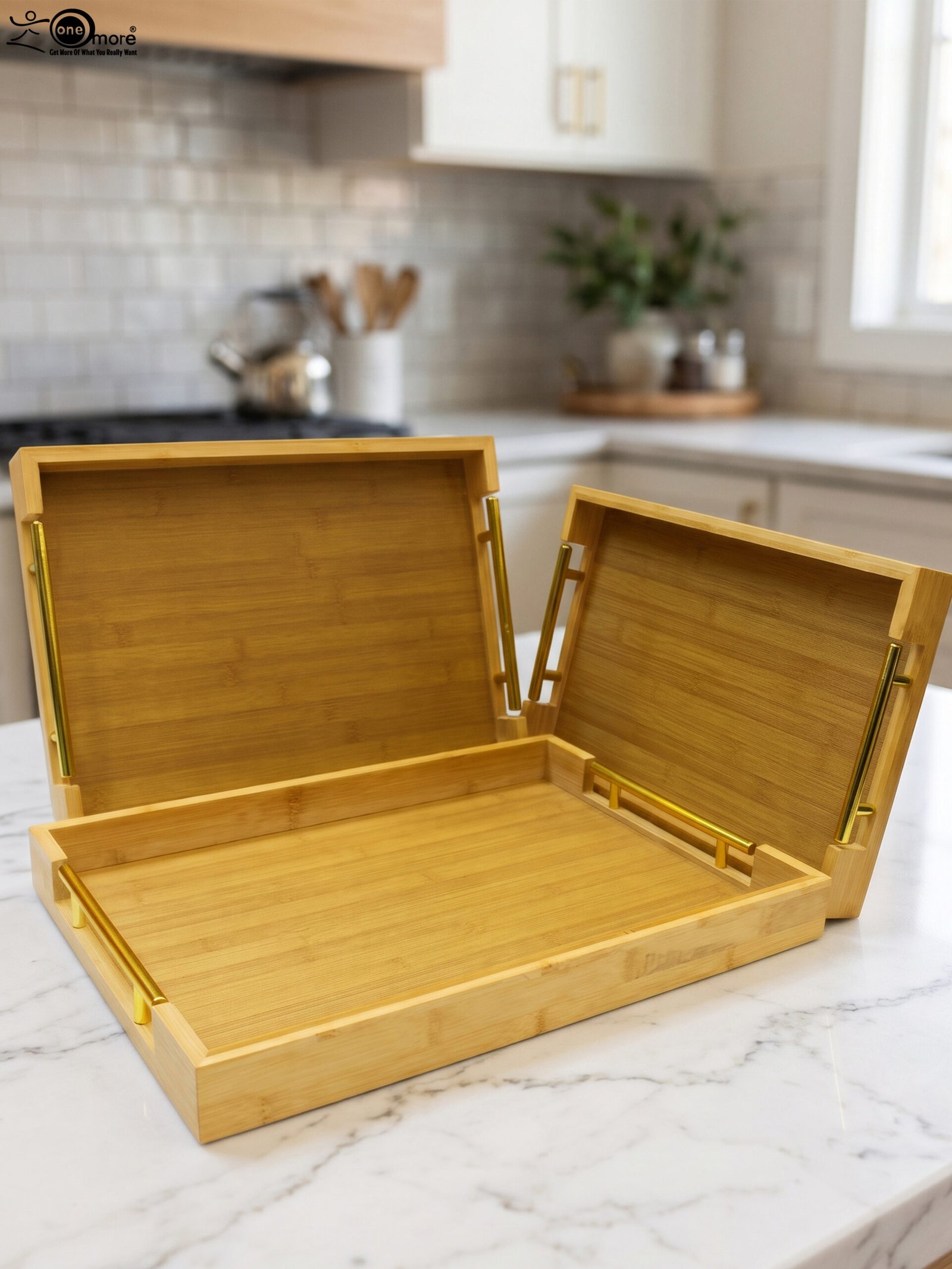 1 Set of three rectangular natural wood serving trays with gold metal handles displayed on a white marble kitchen countertop.