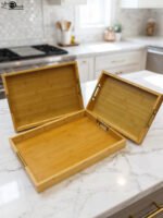 ONEMORE 3 piece natural wooden serving tray set with metallic brass handles resting on a kitchen countertop