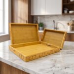 3 piece natural wooden serving tray set with cut-out side handles and engraved geometric border design displayed on a marble kitchen counter