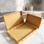 Three-piece natural wooden serving tray set with decorative floral side cutouts displayed on a marble kitchen counter.
