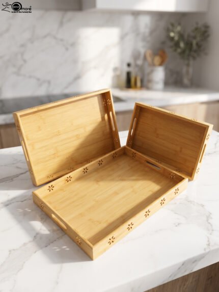 Three-piece natural wooden serving tray set with decorative floral side cutouts displayed on a marble kitchen counter.