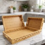 Set of 3 ONEMORE natural wood serving trays with carved geometric side patterns and built-in handles on a marble countertop