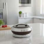 Round dark wood grain insulated hotpot casserole with a sparkling rhinestone base and chrome lid handle on a white kitchen countertop