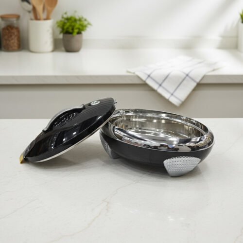 Glossy black insulated stainless steel hotpot casserole with silver chrome accents and lid open on a kitchen countertop.