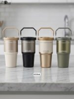 Four UYLEE 600ml stainless steel insulated travel tumblers with folding handles shown in beige, matte black, champagne gold, and olive green on a marble countertop.