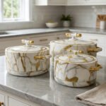 ONEMORE 3-piece luxury white and gold marble pattern hot pot set with gold handles on a marble kitchen countertop.