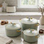 ONEMORE 3-piece sage green insulated hot pot set with polished gold handles and knobs on a marble countertop in 1L, 2L, and 3.5L sizes.