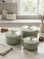 ONEMORE 3-piece sage green insulated hot pot set with polished gold handles and knobs on a marble countertop in 1L, 2L, and 3.5L sizes.