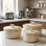 ONEMORE 3 piece off-white and gold insulated hot pot set in 1L, 2L, and 3.5L sizes displayed on a marble kitchen counter.