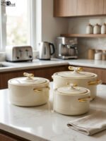 ONEMORE 3 piece off-white and gold insulated hot pot set in 1L, 2L, and 3.5L sizes displayed on a marble kitchen counter.