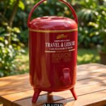 Red DAY DAYS 9.5 liter insulated portable water cooler jug with dispenser tap and foldable legs on a wooden picnic table.