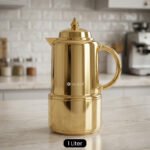 Polished metallic gold 1-liter thermal vacuum flask for coffee and tea displayed on a marble kitchen countertop