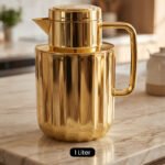 One More 1 liter luxury polished gold vacuum insulated flask with a fluted ribbed design on a marble countertop.
