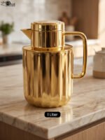 One More 1 liter luxury polished gold vacuum insulated flask with a fluted ribbed design on a marble countertop.