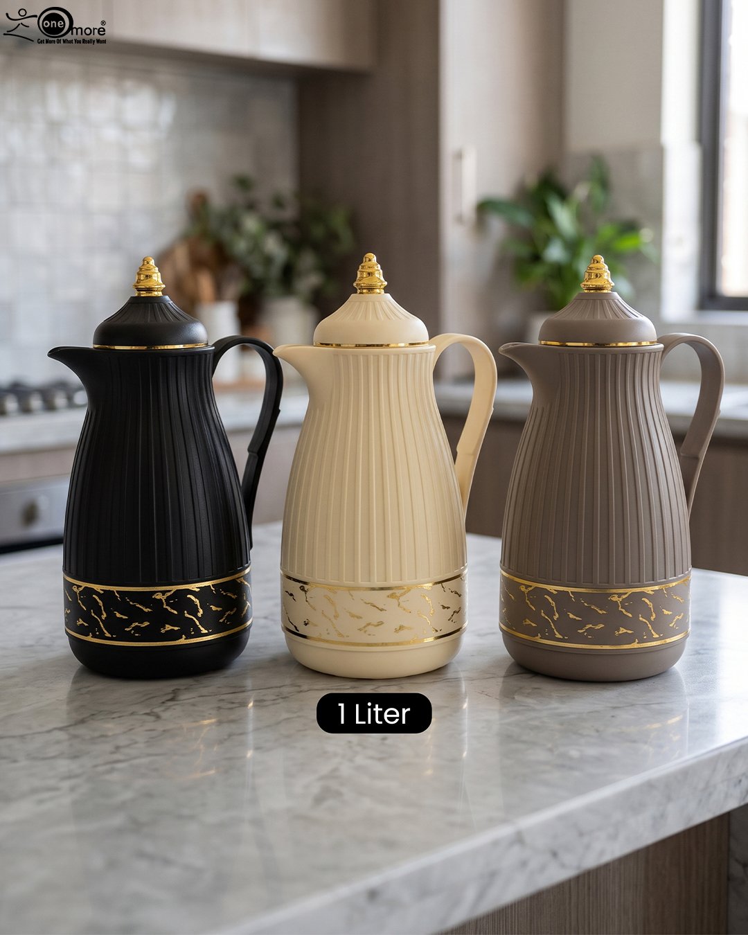 1 Three ONE MORE 1-liter ribbed luxury vacuum flasks in black, cream, and taupe with gold top finials on a marble kitchen counter.