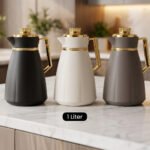Trio of One More 1-liter modern thermal vacuum flasks in matte black, off-white, and gray featuring luxurious gold handles and caps displayed on a marble kitchen countertop.Trio of One More 1-liter modern thermal vacuum flasks in matte black, off-white, and gray featuring luxurious gold handles and caps displayed on a marble kitchen countertop.Trio of One More 1-liter modern thermal vacuum flasks in matte black, off-white, and gray featuring luxurious gold handles and caps displayed on a marble kitchen countertop.Trio of One More 1-liter modern thermal vacuum flasks in matte black, off-white, and gray featuring luxurious gold handles and caps displayed on a marble kitchen countertop.