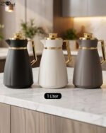 Trio of One More 1-liter modern thermal vacuum flasks in matte black, off-white, and gray featuring luxurious gold handles and caps displayed on a marble kitchen countertop.Trio of One More 1-liter modern thermal vacuum flasks in matte black, off-white, and gray featuring luxurious gold handles and caps displayed on a marble kitchen countertop.Trio of One More 1-liter modern thermal vacuum flasks in matte black, off-white, and gray featuring luxurious gold handles and caps displayed on a marble kitchen countertop.Trio of One More 1-liter modern thermal vacuum flasks in matte black, off-white, and gray featuring luxurious gold handles and caps displayed on a marble kitchen countertop.