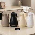 Four One More 1-liter thermal vacuum tea and coffee flasks in taupe, matte black, cream, and white with elegant gold accents on a modern kitchen counter.Four One More 1-liter thermal vacuum tea and coffee flasks in taupe, matte black, cream, and white with elegant gold accents on a modern kitchen counter.