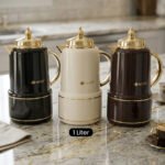 Three luxury 1-liter MIXFF vacuum flasks in black, cream, and dark brown with gold handles and spouts on a marble countertop.Three luxury 1-liter MIXFF vacuum flasks in black, cream, and dark brown with gold handles and spouts on a marble countertop.Three luxury 1-liter MIXFF vacuum flasks in black, cream, and dark brown with gold handles and spouts on a marble countertop.Three luxury 1-liter MIXFF vacuum flasks in black, cream, and dark brown with gold handles and spouts on a marble countertop.