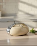 Modern brown insulated hotpot casserole with sleek chrome handle accents on a wooden kitchen countertop