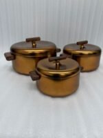 3-piece matte gold thermal hot pot set with dark wooden handles on a marble kitchen countertop