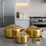 3-piece luxury brushed gold insulated hot pot set with clear acrylic lid handles on a kitchen counter