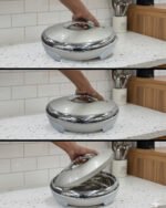 Cream and stainless steel insulated thermal hotpot casserole dish with lid resting on a granite kitchen countertop.