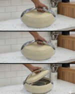 Modern brown insulated hotpot casserole with sleek chrome handle accents on a wooden kitchen countertop