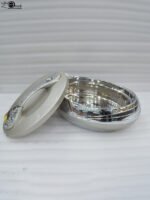 Grey insulated stainless steel hotpot casserole dish with an ornate decorative lid on a modern kitchen countertop
