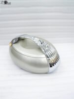 Modern grey insulated hotpot casserole with polished chrome handle on a wooden kitchen countertop