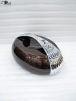 Glossy brown oval insulated hotpot casserole with chrome handle on a modern kitchen countertop.
