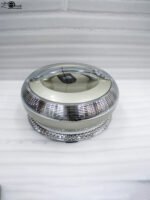 An elegant champagne-colored insulated luxury hotpot casserole with a sparkling crystal rhinestone base and chrome accents, sitting on a dark kitchen countertop.