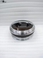 Round dark wood grain insulated hotpot casserole with a sparkling rhinestone base and chrome lid handle on a white kitchen countertop