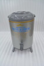 DAYDAYS 9.5-liter gray thermal beverage dispenser jug with dispensing tap and tripod stand sitting on an outdoor wooden picnic table.