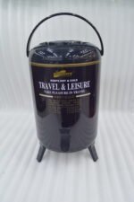 Day Days 9.5 Liter dark blue insulated water cooler jug with spigot tap and tripod legs set on an outdoor picnic table.