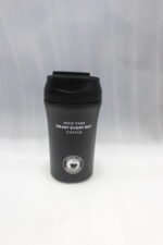 Four 450ml insulated travel coffee mugs in navy blue, olive green, cream, and matte black on a marble kitchen countertop