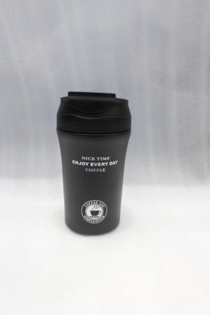 Four 450ml insulated travel coffee mugs in navy blue, olive green, cream, and matte black on a marble kitchen countertop