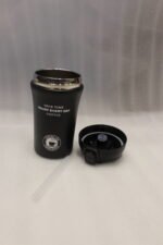 Four 450ml insulated travel coffee mugs in navy blue, olive green, cream, and matte black on a marble kitchen countertop
