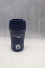 Four 450ml insulated travel coffee mugs in navy blue, olive green, cream, and matte black on a marble kitchen countertop