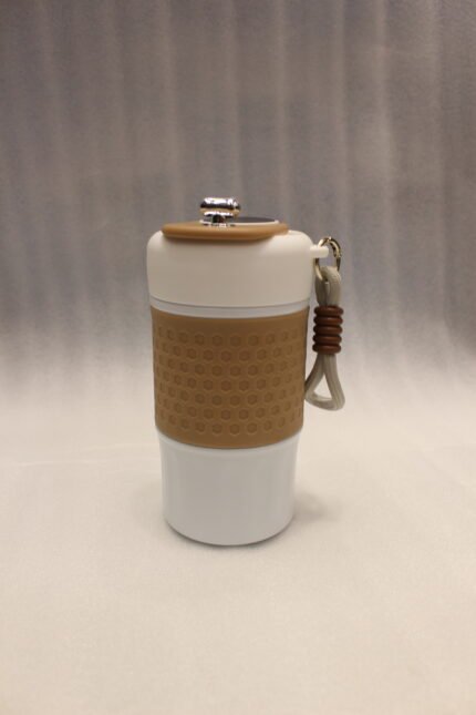 Four 450ml insulated travel coffee mugs in mint green, brown, black, and pink with textured silicone grips and wrist straps on a kitchen counter